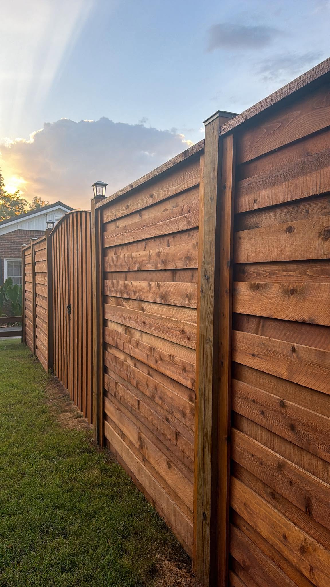 Stained wood privacy fence built by Integrity Fence and Outdoor